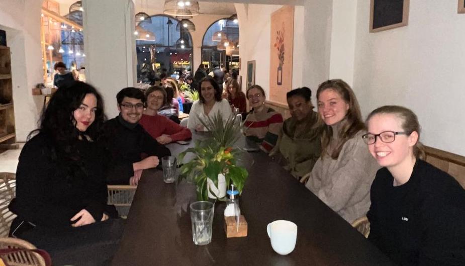 Seven Booth Club members meeting up in a café in Brussels, Belgium, and taking a break from conference interpreting practice.